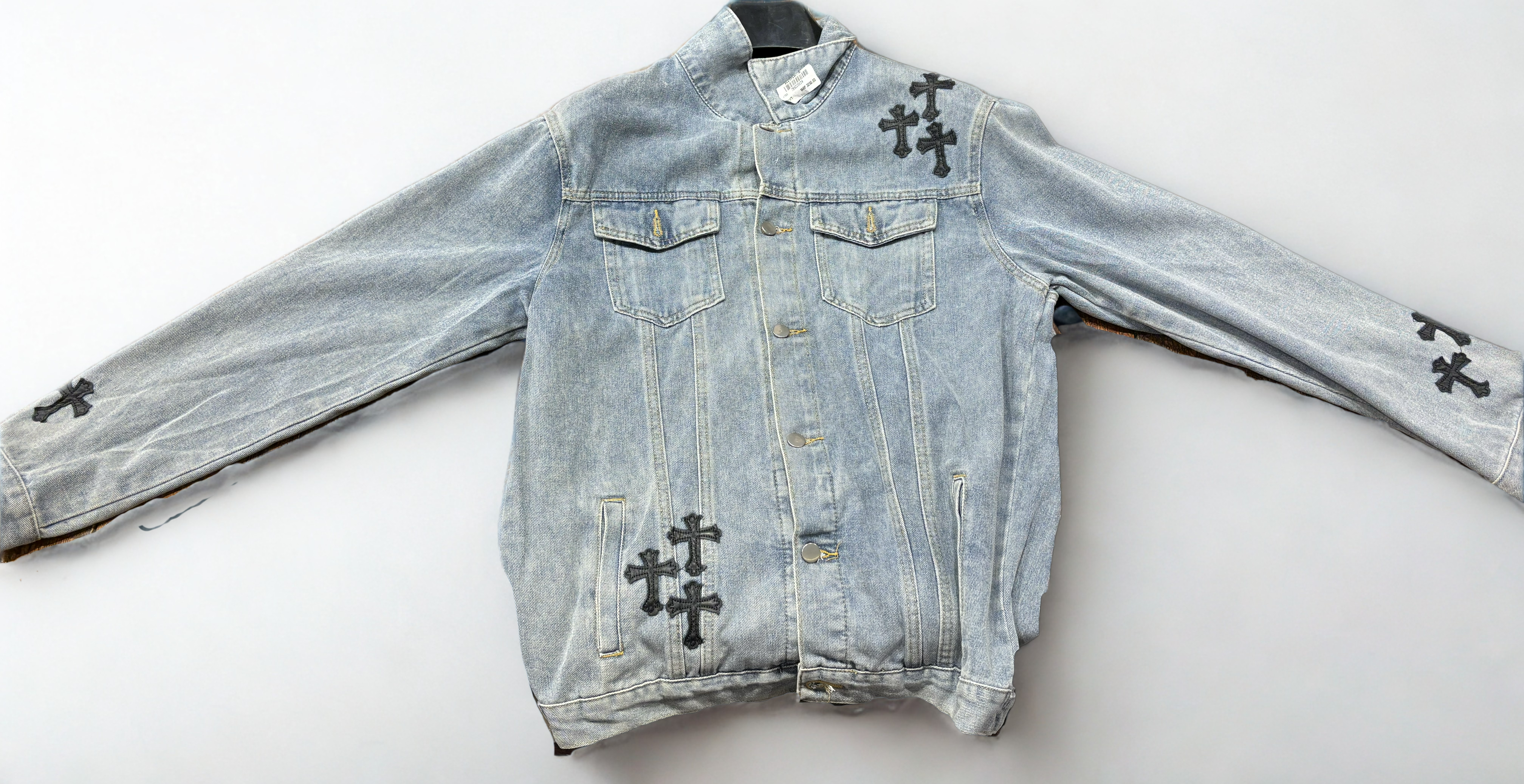 BLUE DENIM WITH LEATHER CROSSES - flat lay